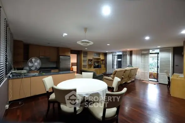 Spacious open-plan living room with dining area and modern kitchen.
