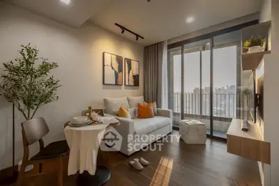 Modern living room with city view, cozy sofa, and stylish decor in a high-rise apartment.
