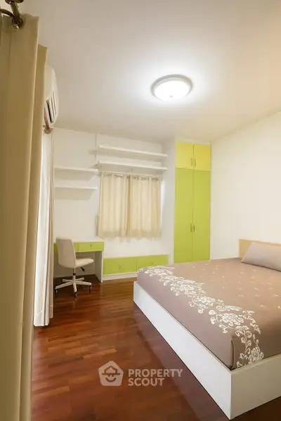 Cozy bedroom with wooden flooring and modern furniture