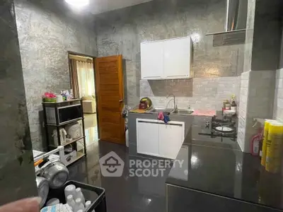 Modern kitchen with sleek countertops and closed layout, featuring stainless steel appliances.