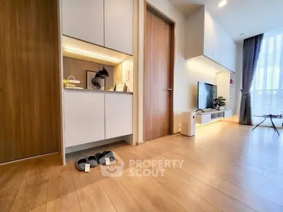 Modern living room with sleek wooden flooring and stylish TV setup