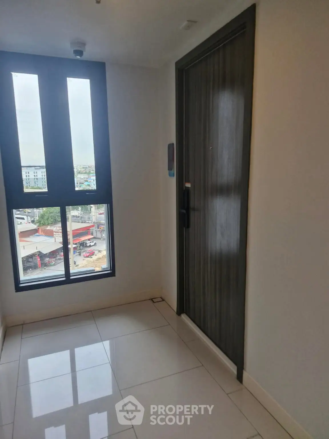 Modern apartment entrance with large window and city view