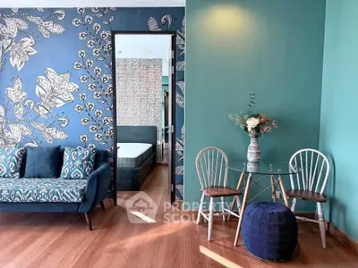 Stylish living room with vibrant decor and a glimpse into a cozy bedroom, featuring elegant furniture and floral accents.