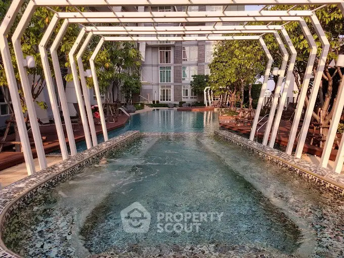 Luxurious apartment pool with modern design and lush greenery