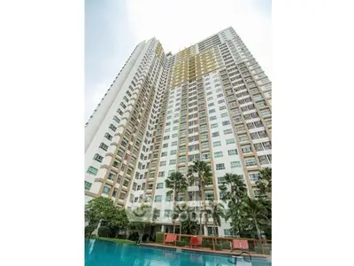 Stunning high-rise building with poolside view and lush greenery, perfect for urban living.