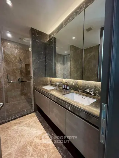 Luxurious modern bathroom with marble finishes and dual sinks