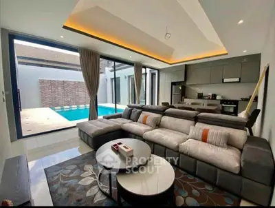 Luxurious living room with pool view and modern open kitchen layout