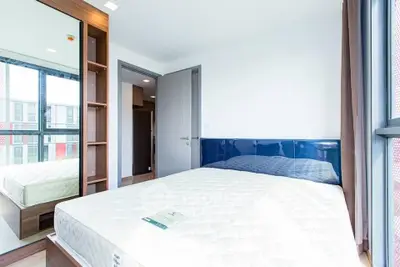 Bright and modern bedroom with large windows and built-in storage