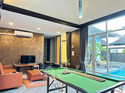 Luxurious living room with pool table and pool view, perfect for entertainment and relaxation.