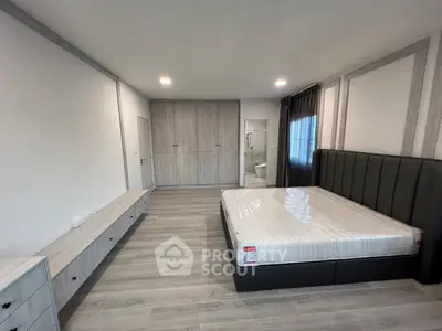 Spacious modern bedroom with sleek design and ample storage space