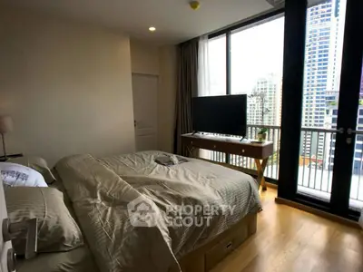 Luxurious bedroom with city view and modern furnishings in high-rise apartment