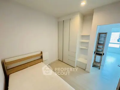 Modern minimalist bedroom with built-in wardrobe and natural light
