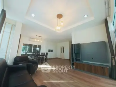 Spacious living room with modern lighting and elegant dining area