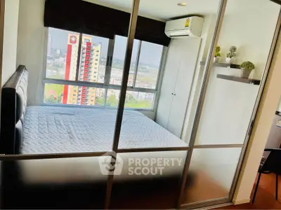 Modern bedroom with large windows offering city view and sleek glass partition.