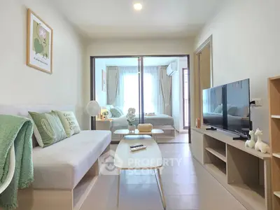 Modern living room with cozy decor and view into a stylish bedroom, perfect for urban living.