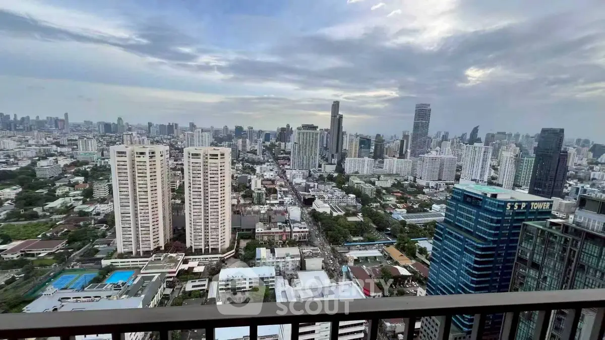 Stunning cityscape view from high-rise balcony with expansive skyline and urban landscape.