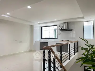 Modern kitchen with sleek design and open layout, featuring gas stove and ample natural light.