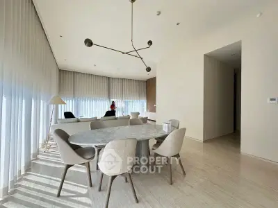 Spacious modern living room with elegant dining area and stylish lighting