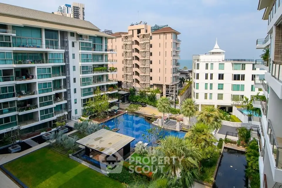 Luxurious residential complex with pool and garden view, modern architecture, and lush landscaping.