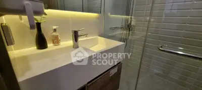 Modern bathroom with sleek sink and glass shower enclosure