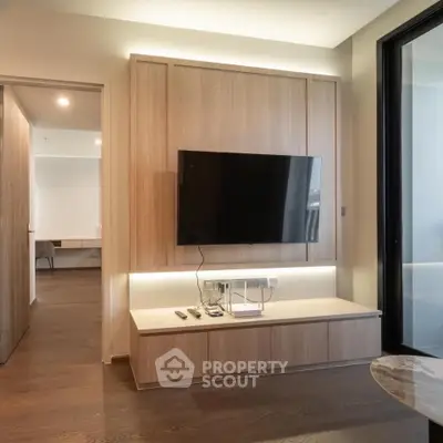 Modern living room with sleek TV setup and elegant wooden paneling