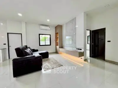 Modern living room with sleek design and large windows for natural light.