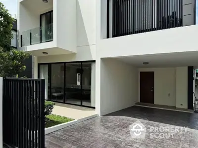 Modern townhouse exterior with sleek design and spacious driveway