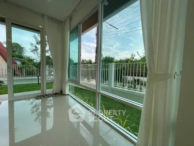 Spacious living room with large windows and garden view