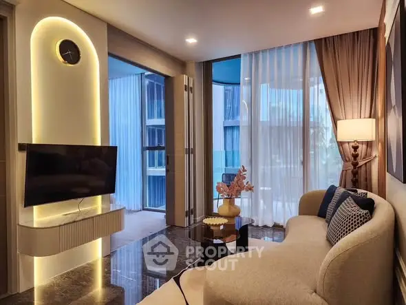 Luxurious modern living room with elegant decor and large windows offering natural light.