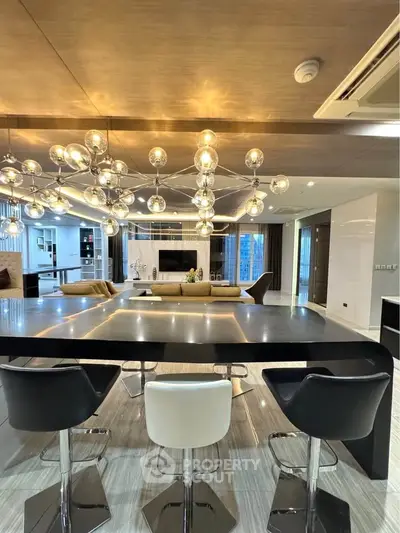 Luxurious modern living room with stylish lighting and sleek furniture, perfect for entertaining.
