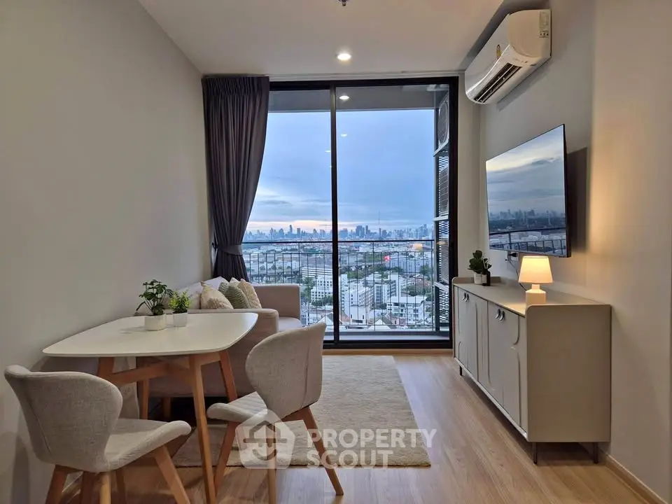 Modern living room with city view, featuring sleek furniture and large windows for natural light.