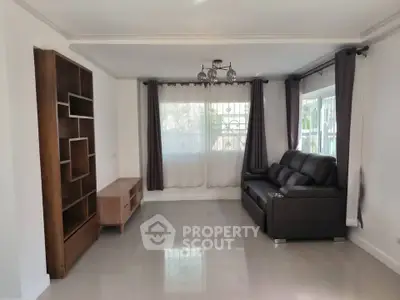 Spacious living room with modern furniture and large windows for natural light.