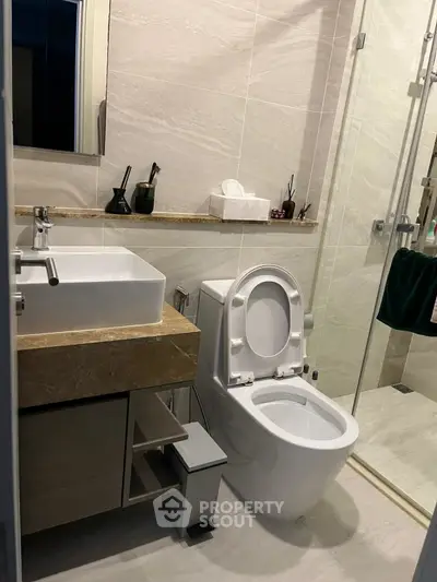Modern bathroom with sleek fixtures and glass shower enclosure