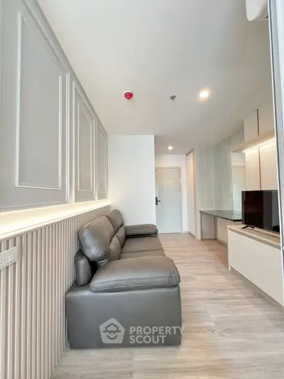 Modern living room with sleek design and comfortable seating in a stylish apartment.