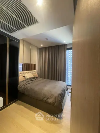 Modern bedroom with elegant design and city view, featuring cozy bed and stylish decor.