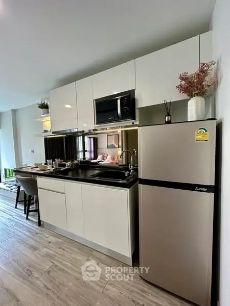 Modern kitchen with sleek cabinetry and stainless steel appliances in open layout