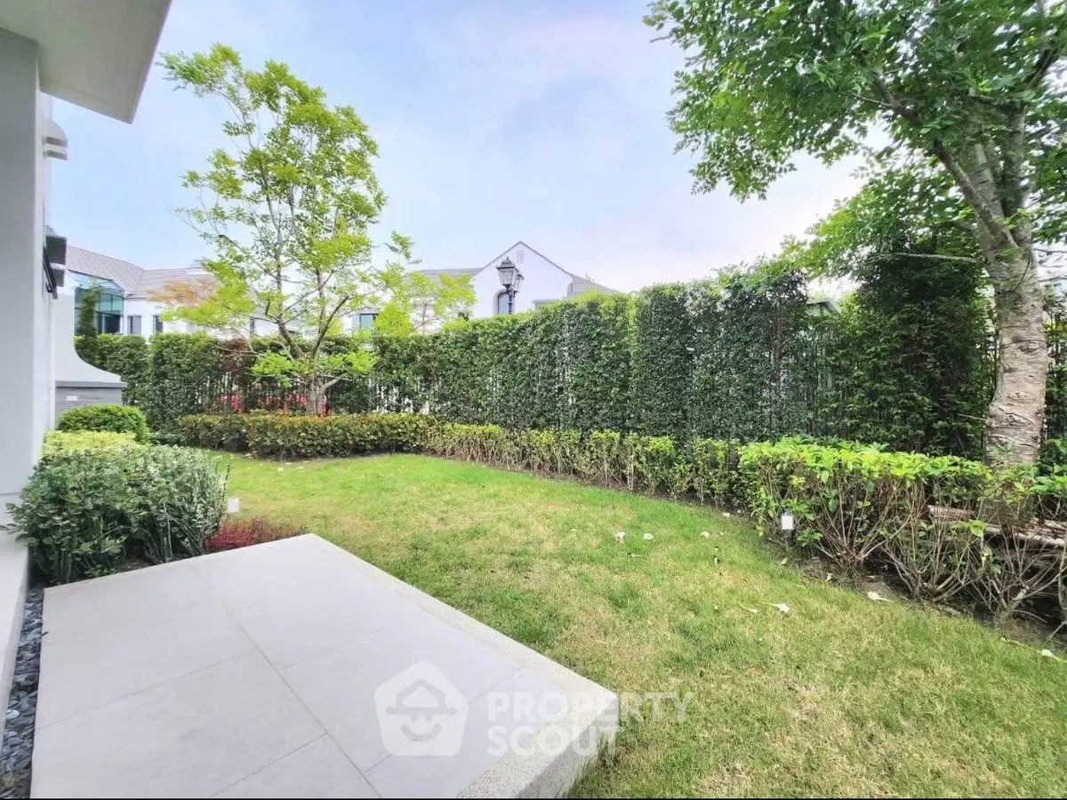 Charming garden view with lush greenery and cozy patio area, perfect for relaxation and outdoor enjoyment.