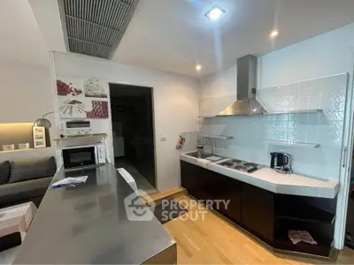 Modern kitchen with sleek appliances and open layout in stylish apartment