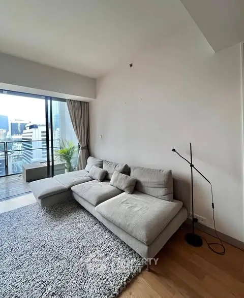 Modern living room with cozy sofa and city view balcony