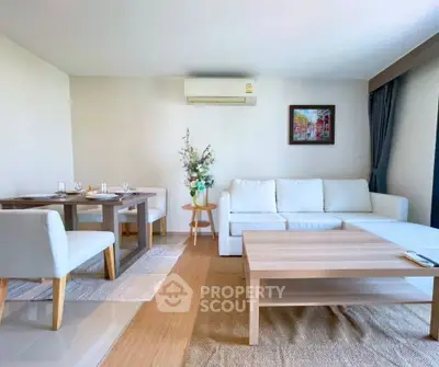 Spacious living room with modern furniture and elegant decor in a cozy apartment.