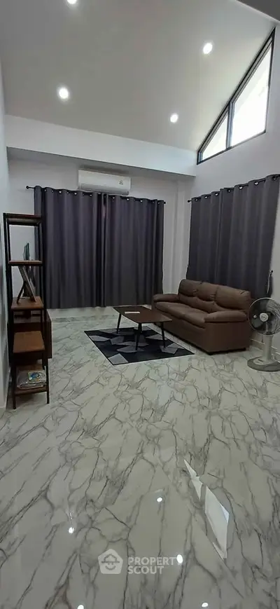 Spacious living room with modern sofa and elegant marble flooring