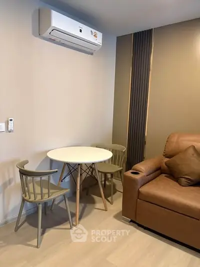 Cozy living room with modern air conditioning and stylish furniture, perfect for relaxation.