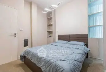 Modern bedroom with stylish lighting and cozy bedding