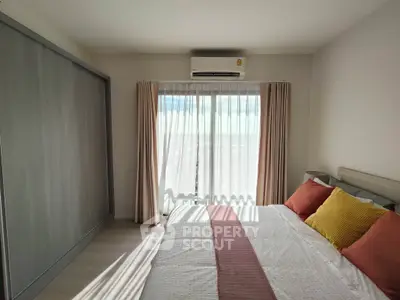 Bright bedroom with large window and modern decor