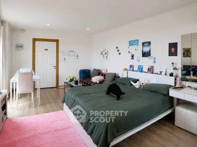 Spacious bedroom with modern decor and ample natural light