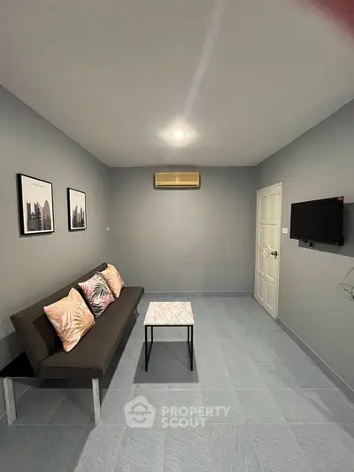 Modern minimalist living room with sleek gray walls and stylish decor