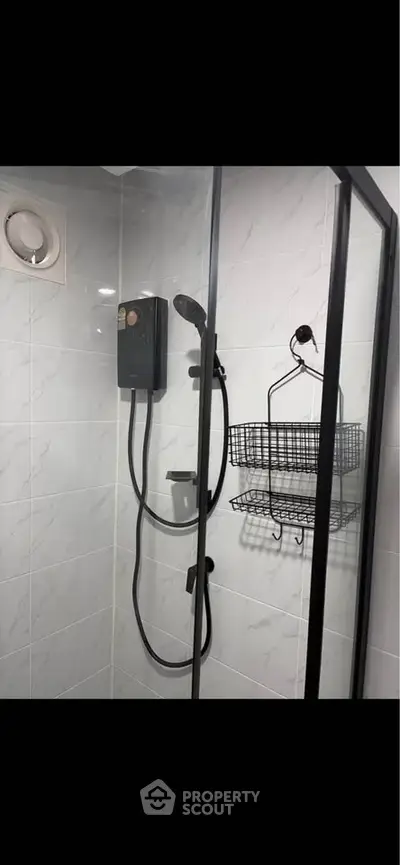Modern bathroom with glass shower enclosure and sleek fixtures