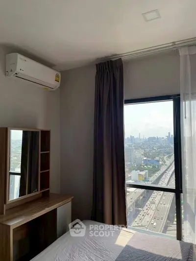 High-rise bedroom with city view and air conditioning