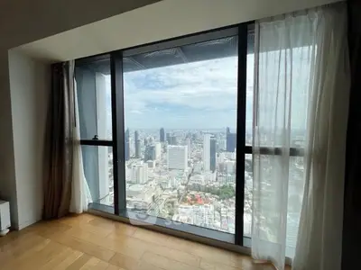Stunning high-rise apartment with panoramic city view through large windows.