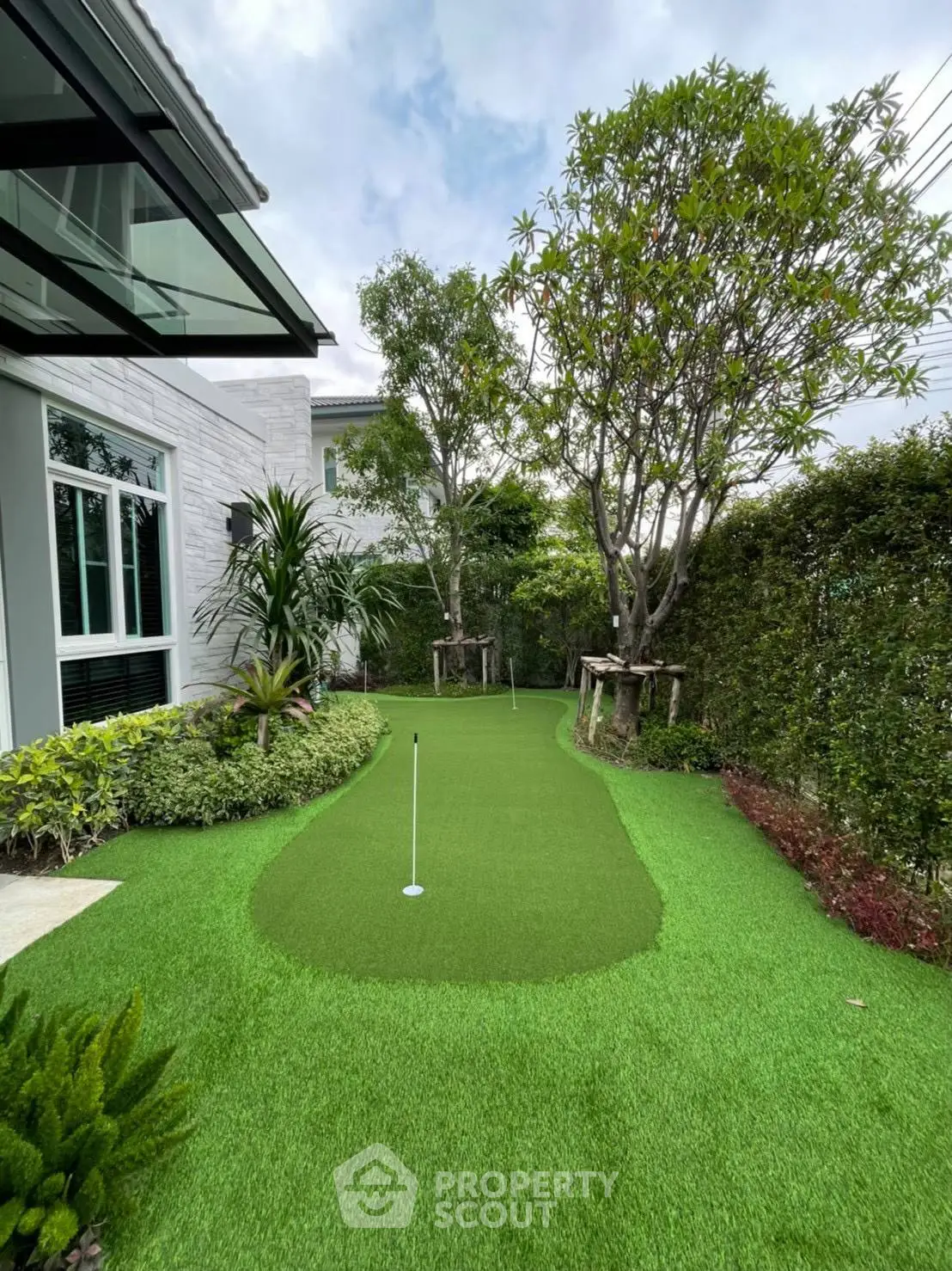 Luxurious home with private putting green in lush garden setting